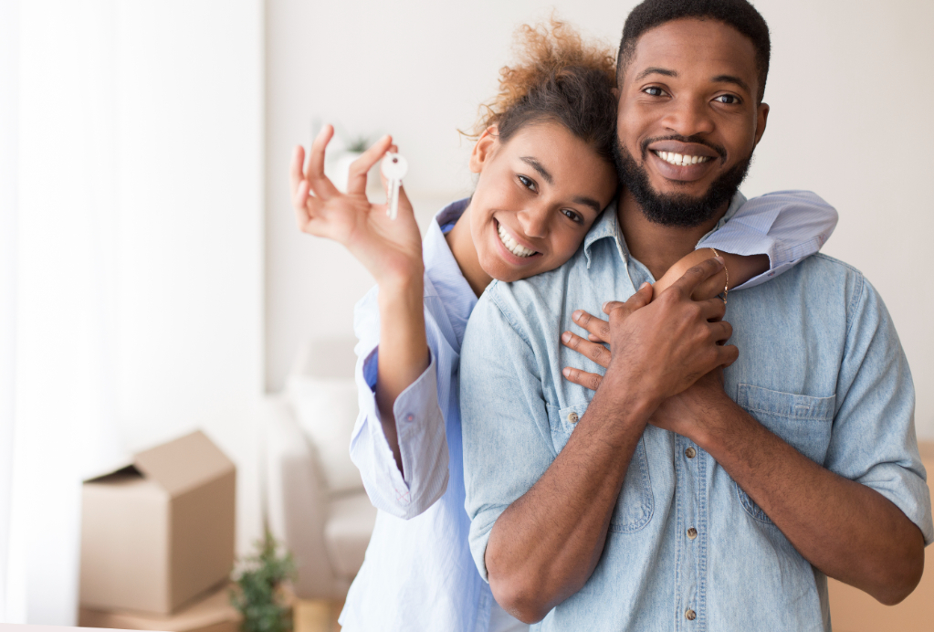 Afro spouses showing key to home
